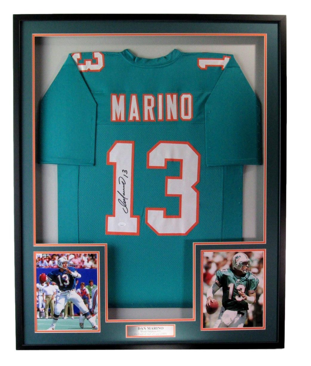 Framed Miami Dolphins Dan Marino jersey, teal and orange, with two photos of Marino in action.