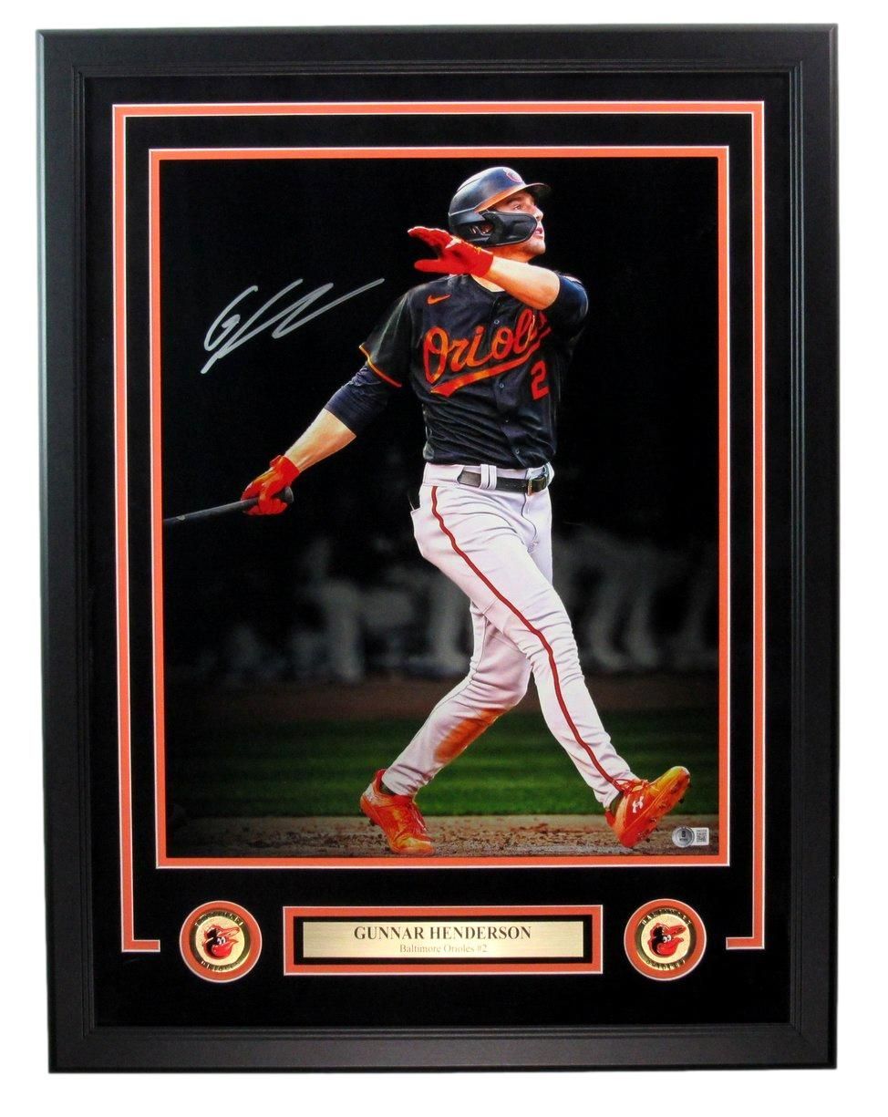 Framed baseball photo of Gunnar Henderson hitting, wearing Orioles uniform. Includes signature and team logos.