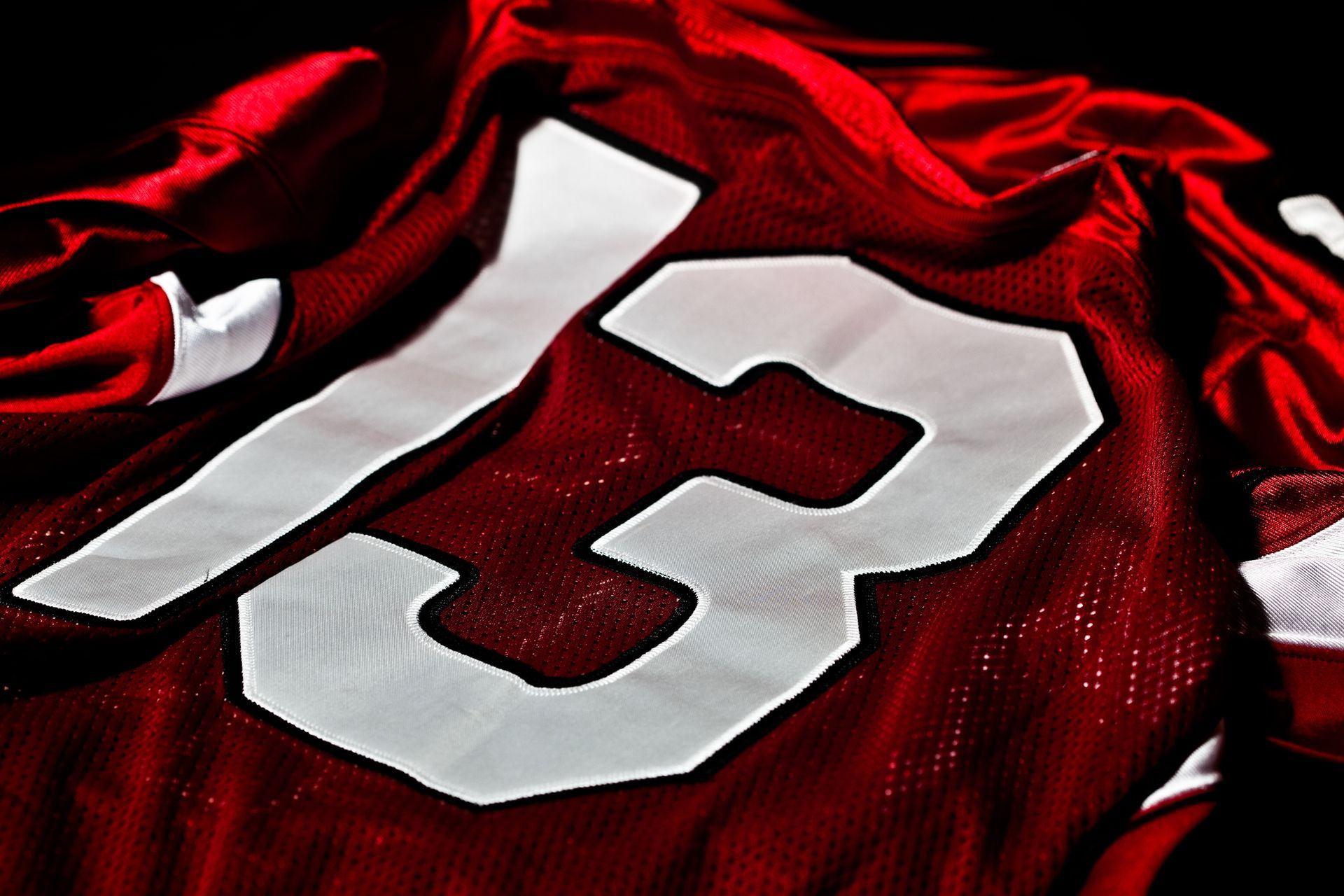 Red and white vintage jersey close up, featured as silent auction sports memorabilia.