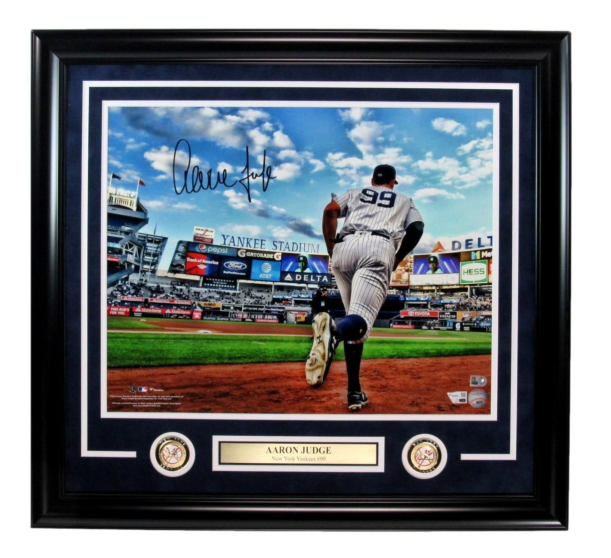 Framed photo of Aaron Judge in Yankees uniform, throwing a baseball at Yankee Stadium. Signed autograph visible.