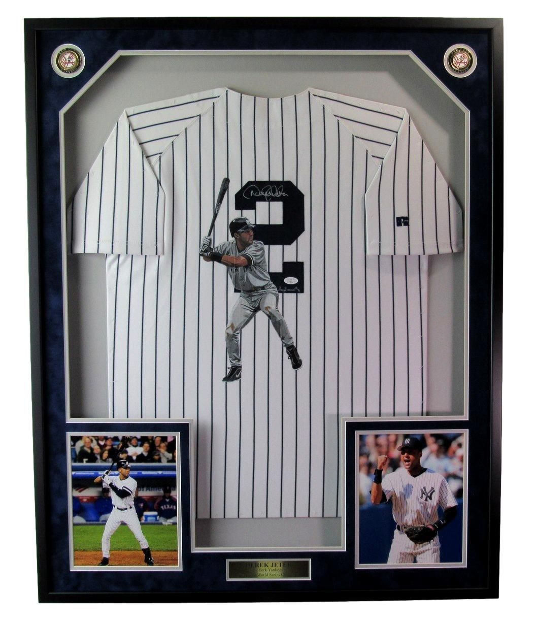 Framed Derek Jeter Yankees jersey and photos. Jersey with player image, two photos, and blue frame.