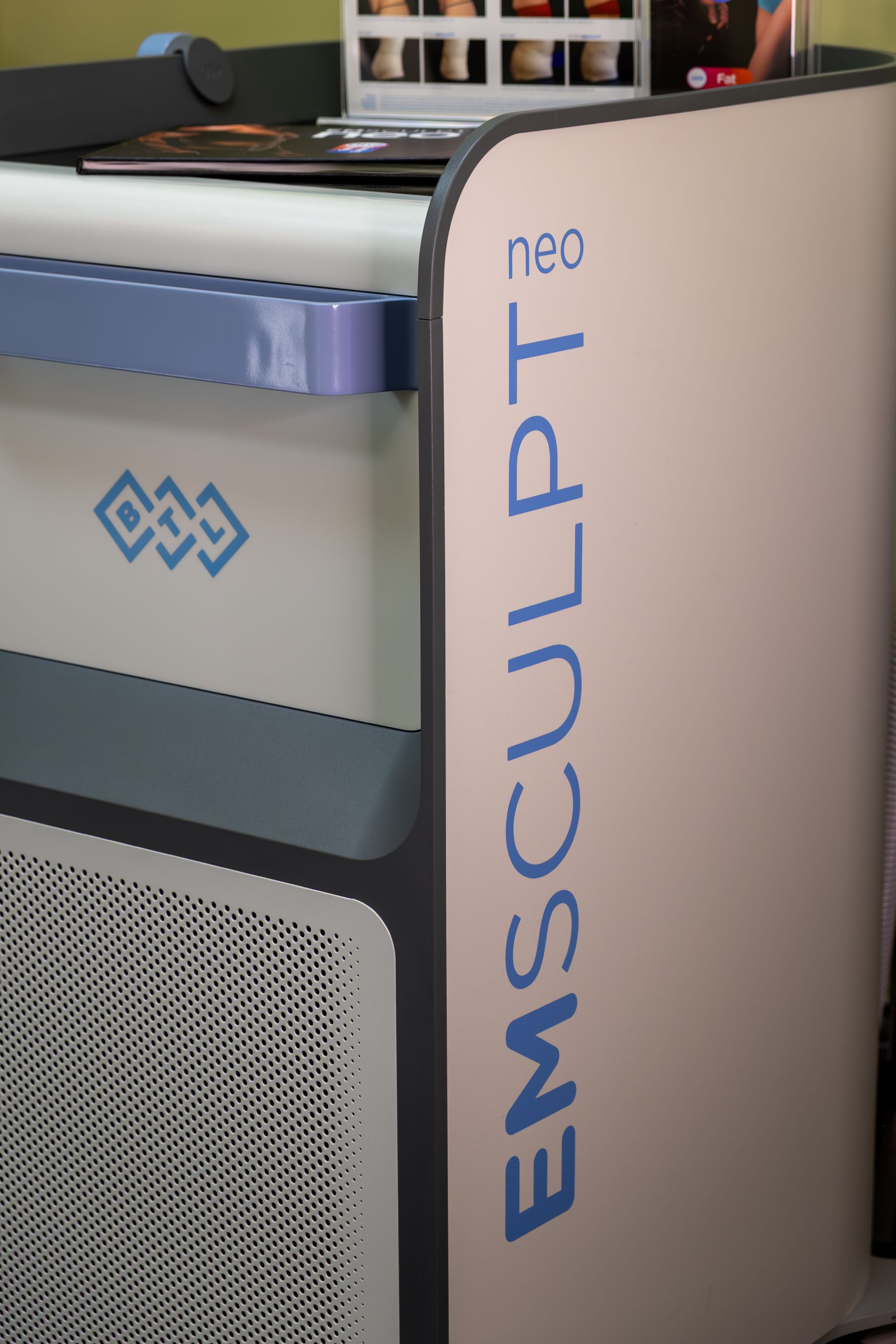 EMSCULPT Neo machine with blue logo and white side panel in a clinic setting