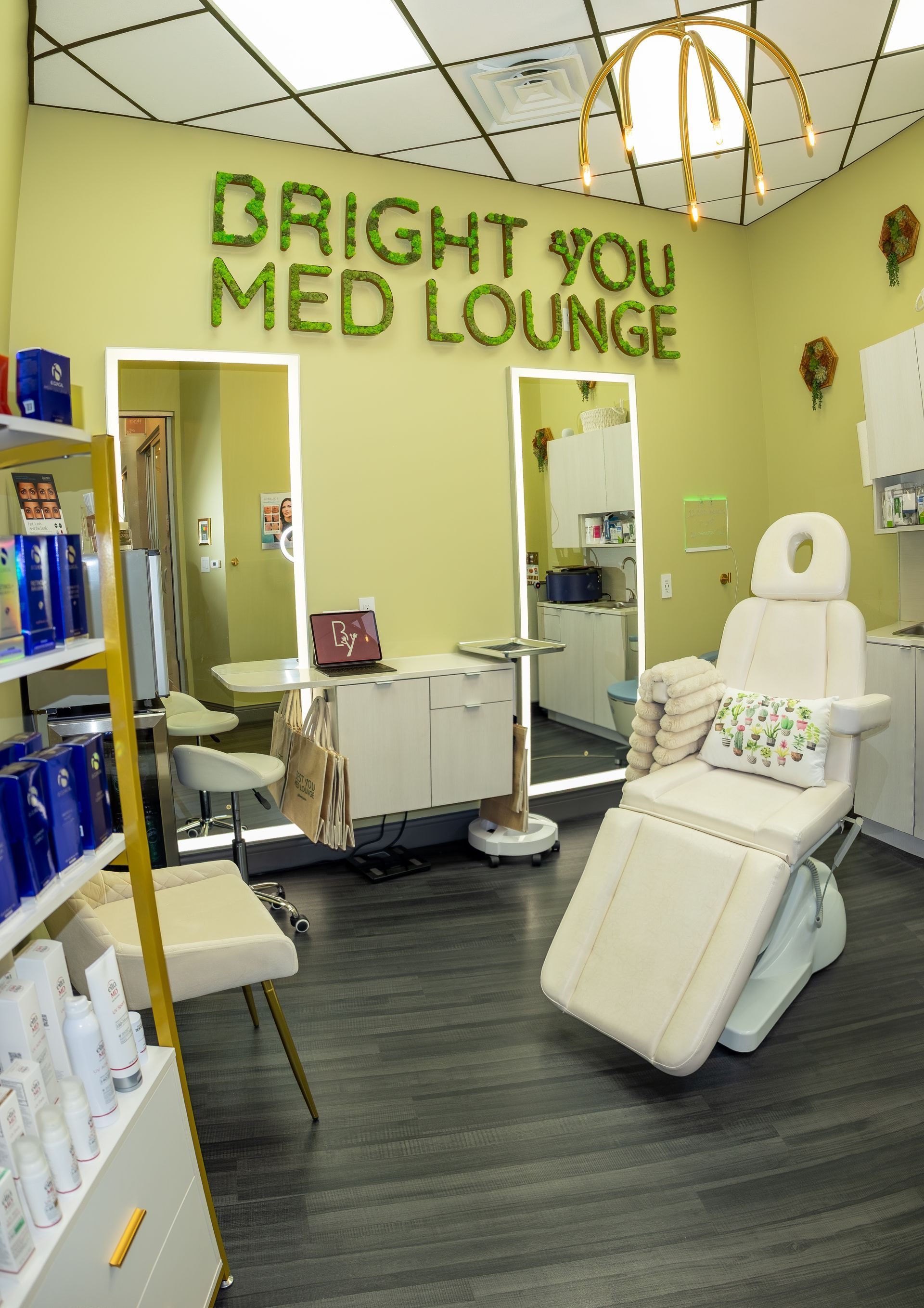 Bright You Med Lounge interior with treatment chair, mirrors, and product display.