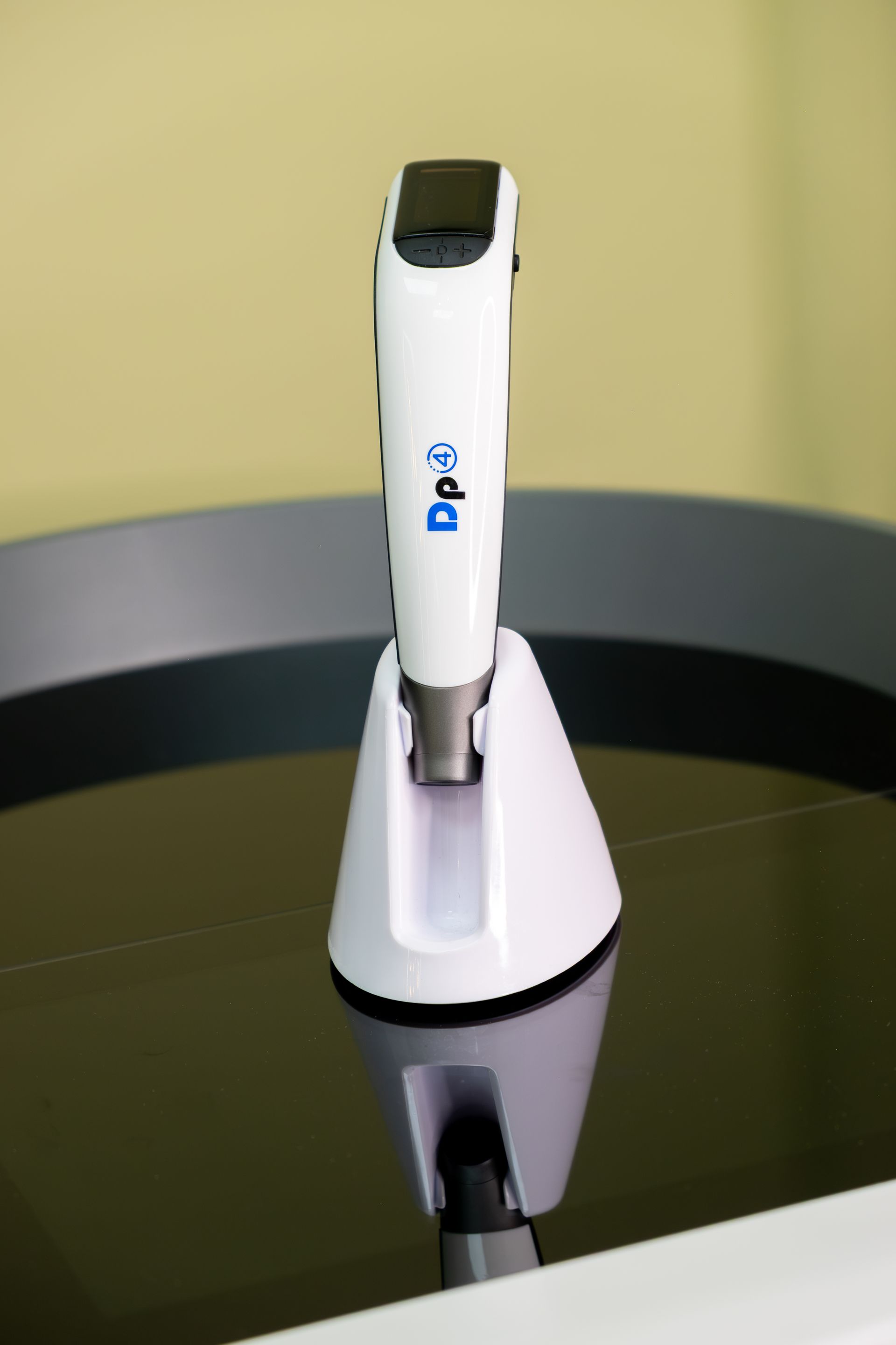 A white device is sitting on top of a black table.