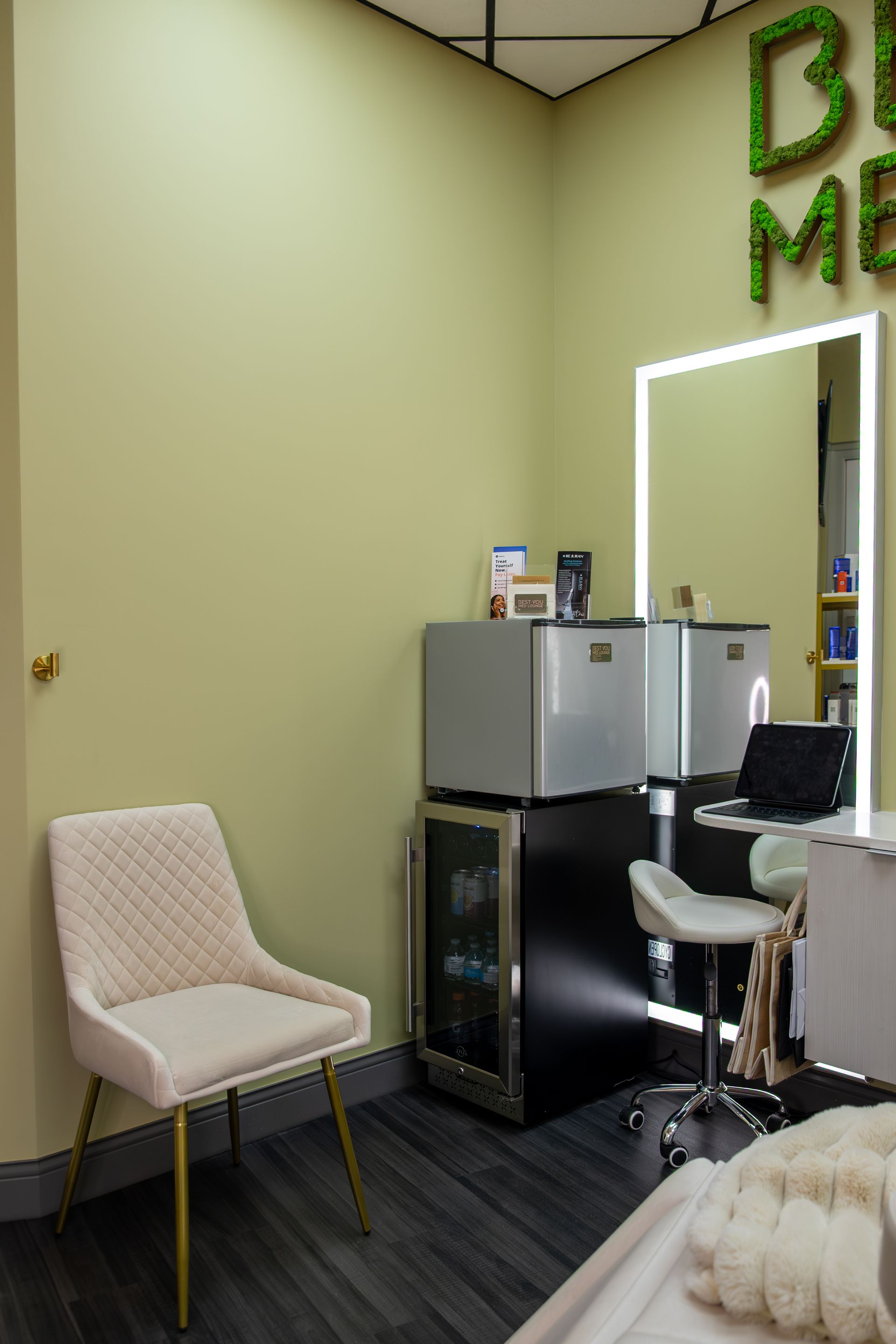 A room with a chair and a refrigerator in it