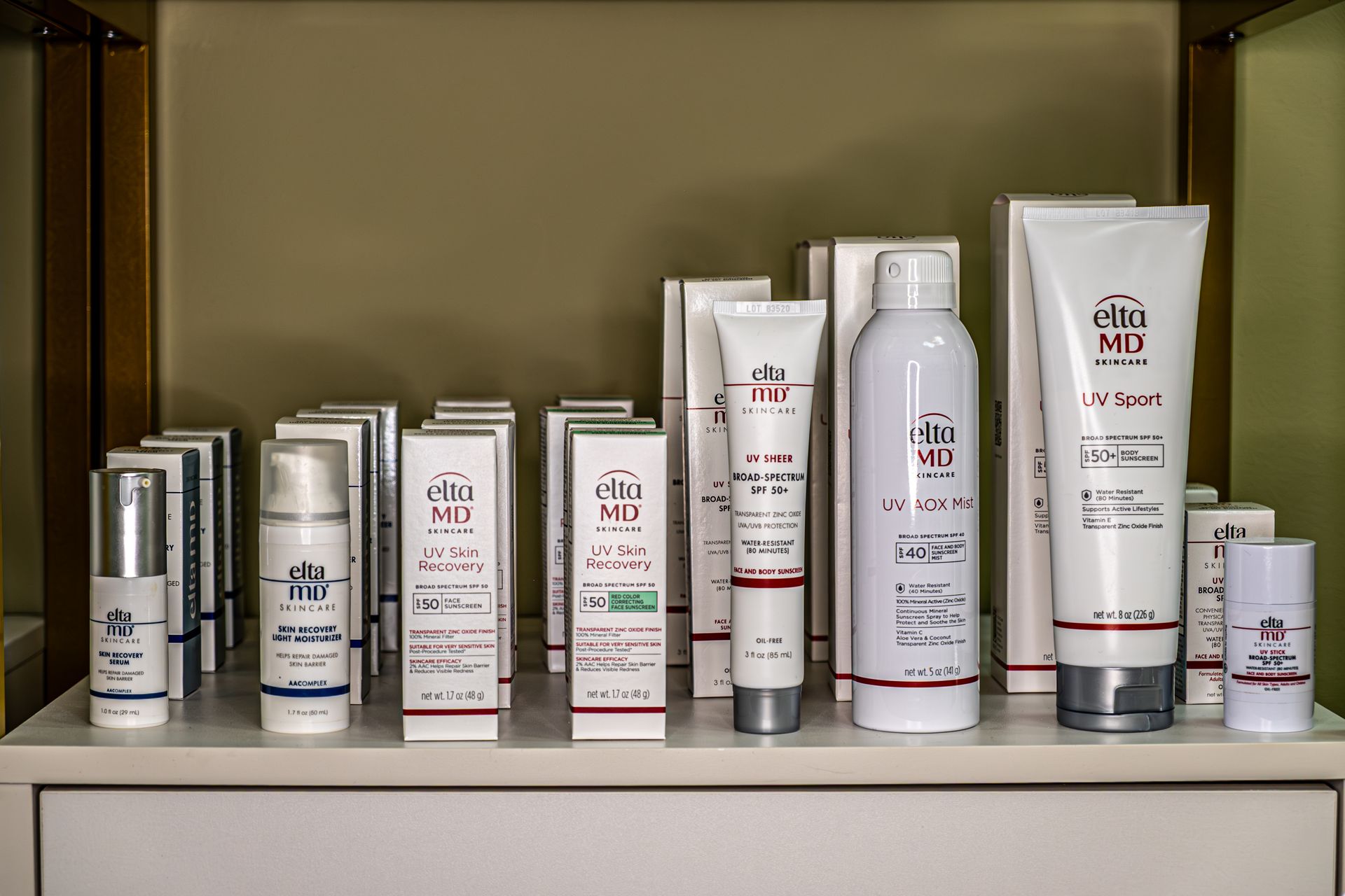 A shelf filled with a variety of skin care products