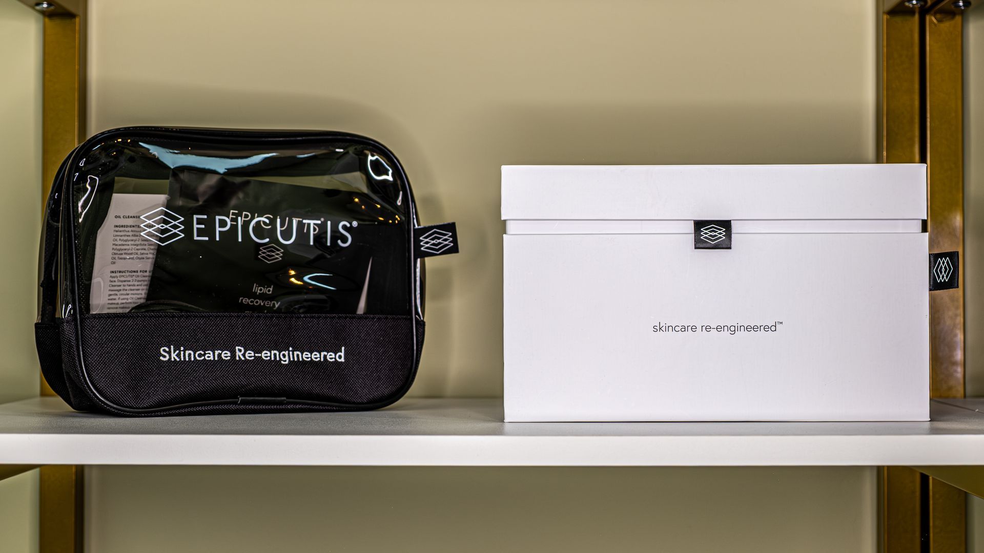 A clear bag and a white box are on a shelf.