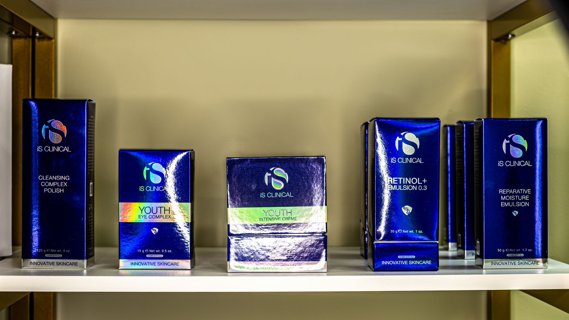 A shelf filled with a variety of blue boxes of cosmetics.