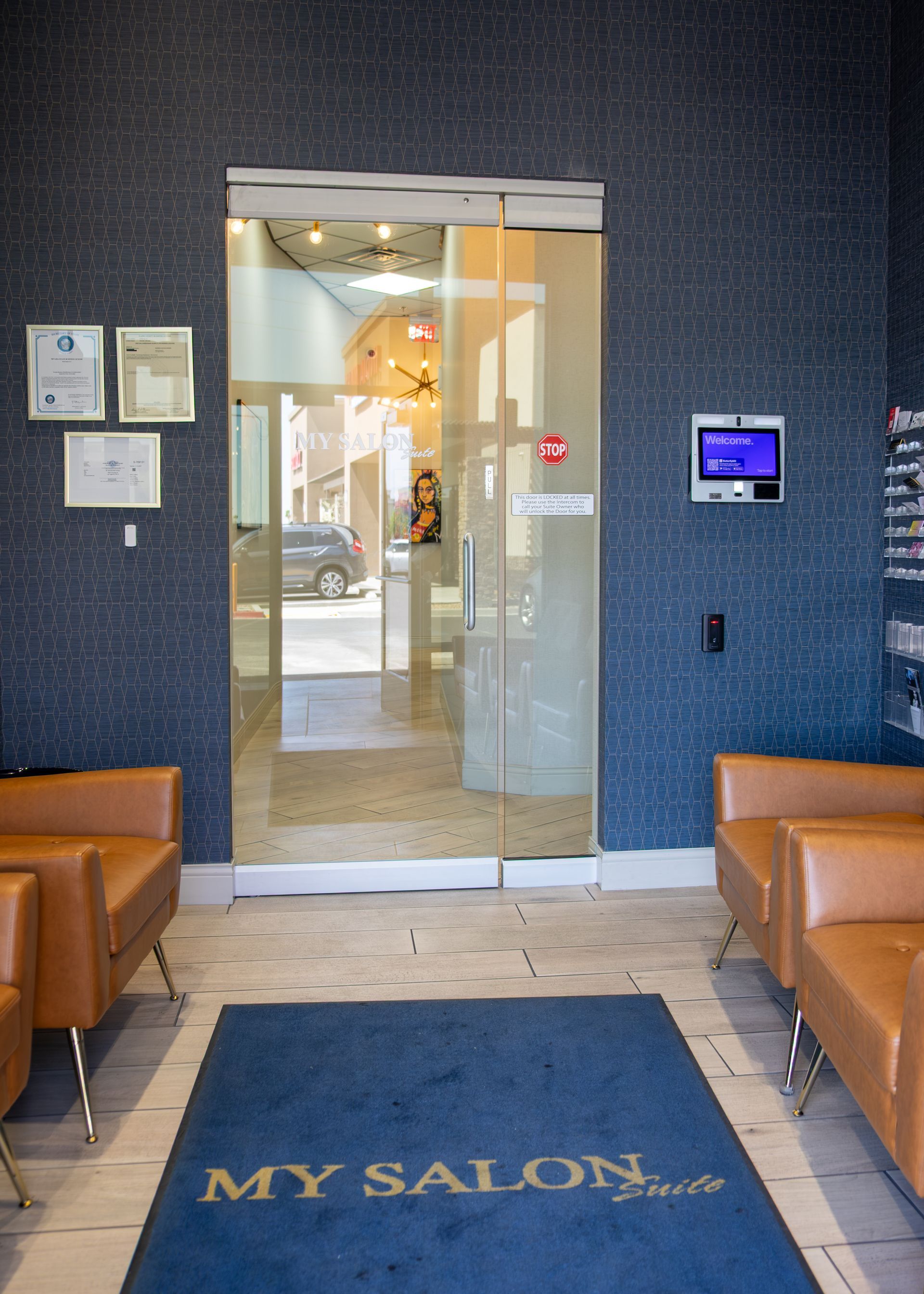 A waiting room with a blue rug that says my salon