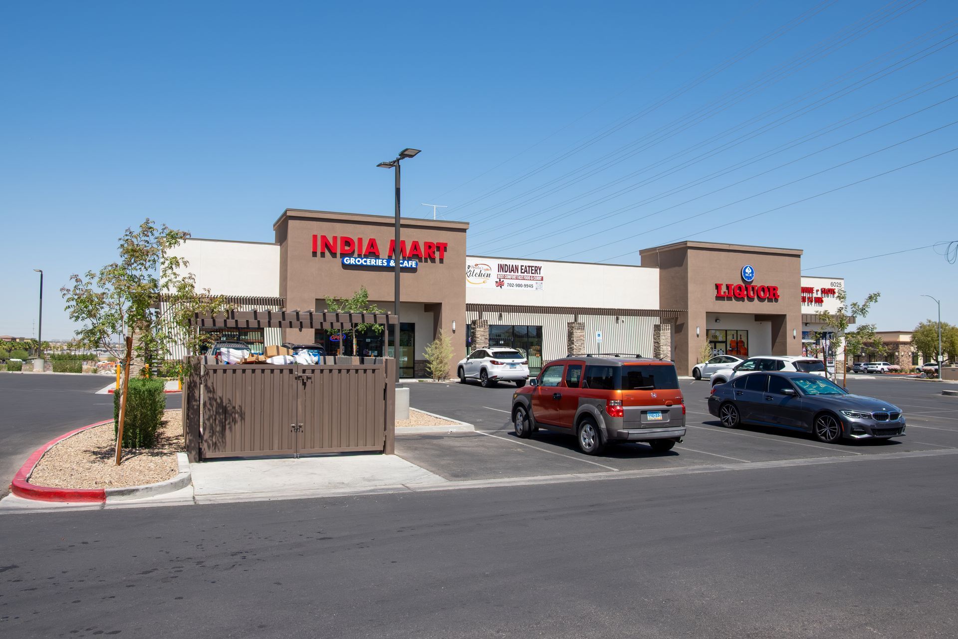 A group of cars are parked in front of a store called india mart.