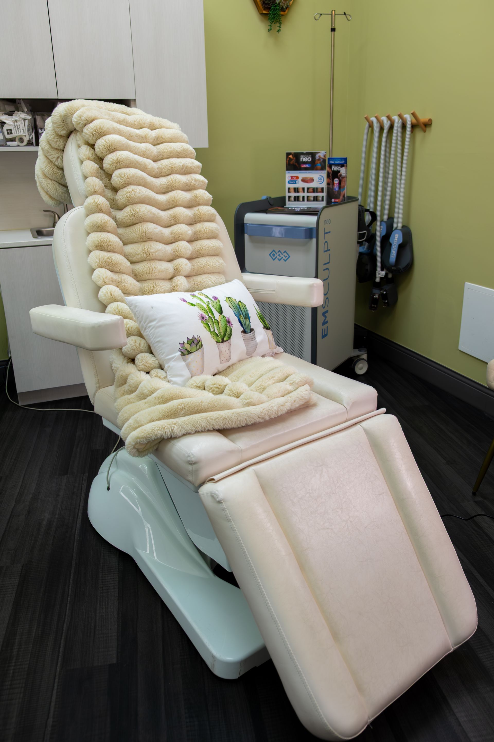 A chair with a blanket and a pillow on it in a room.