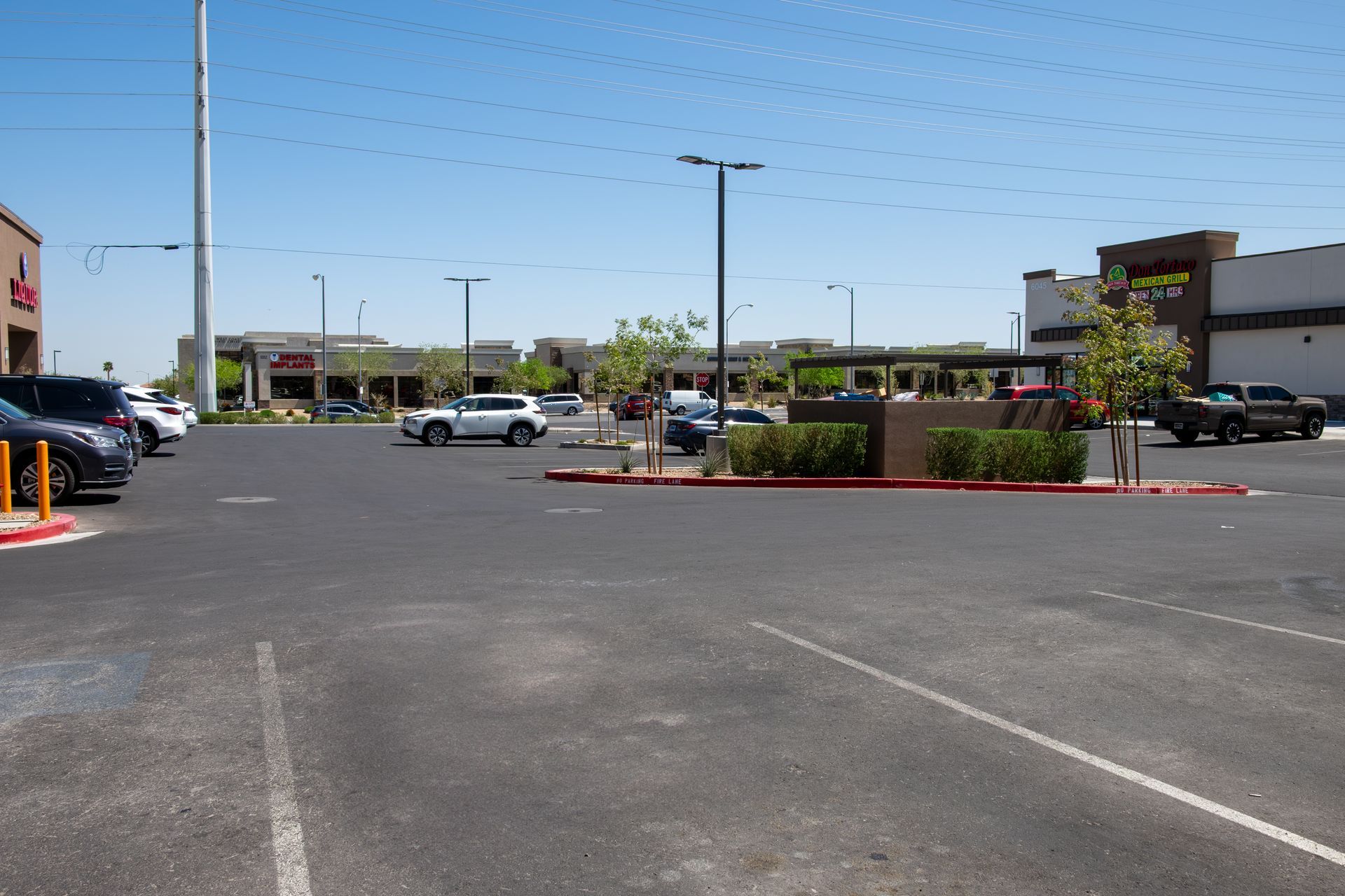 A parking lot with cars parked in front of a store