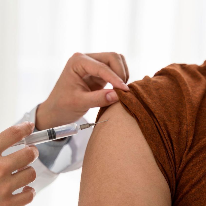 A person is getting an injection in their arm