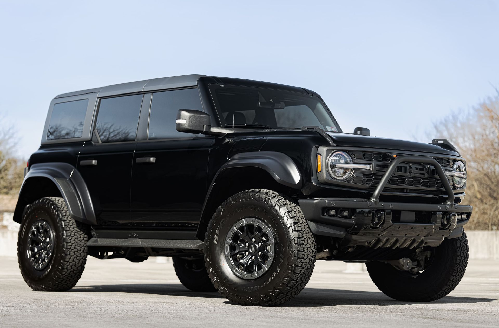 Black Ford Bronco SUV with off-road modifications, parked outdoors.