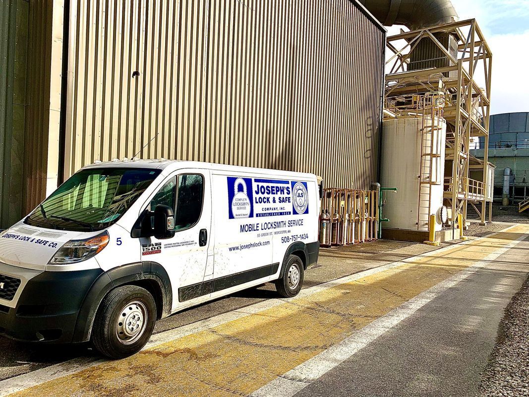 A white van is parked in front of a building.