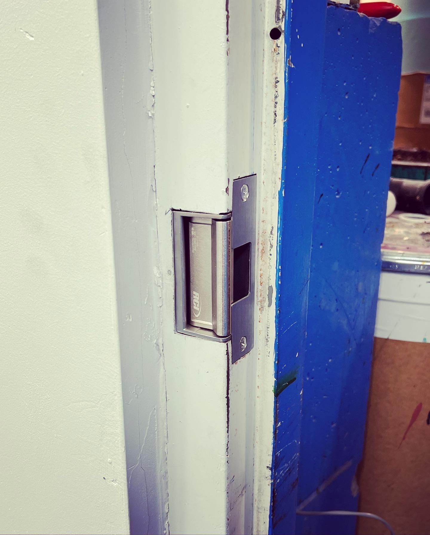 A blue door with a stainless steel door latch