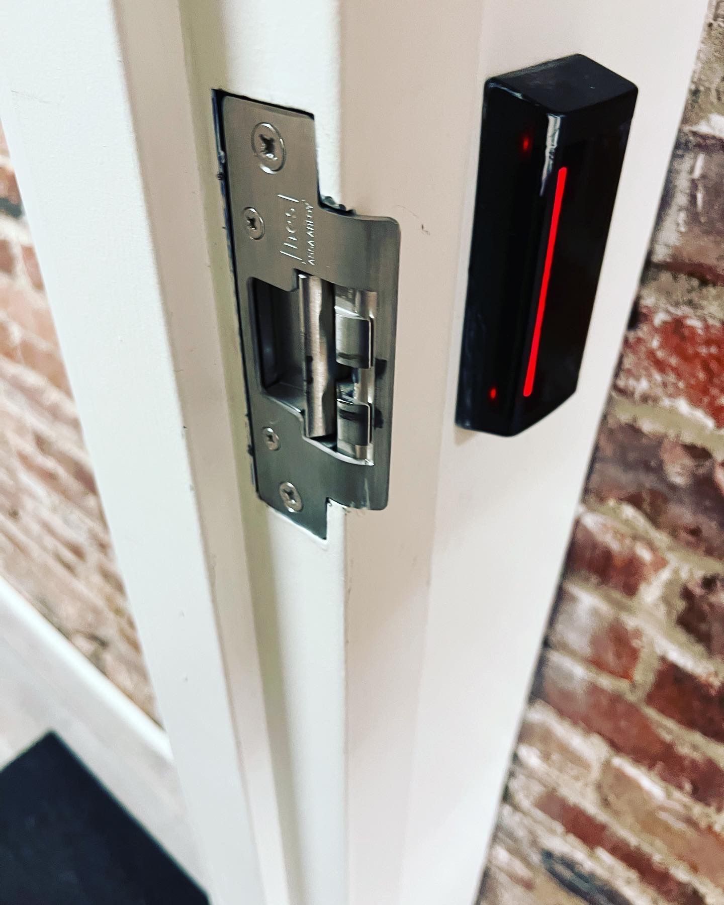 A close up of a door with a red light on it.