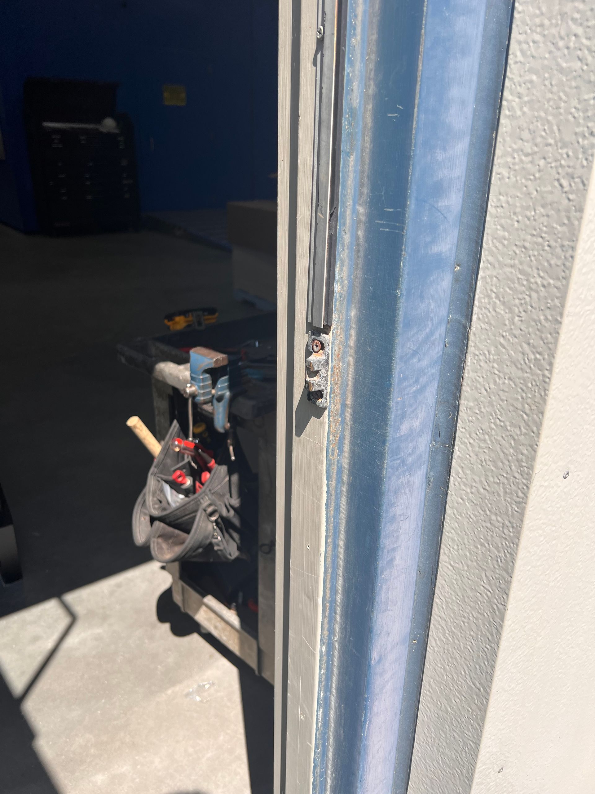 A close up of a door with a tool bag hanging from it.