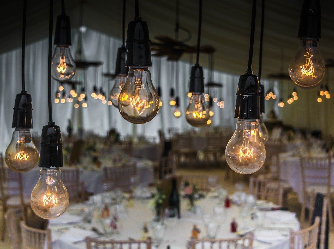 photo of rustic lightbulbs overhanging an event space for a wedding