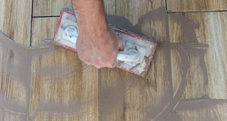 Spreading Grout — Tiling Service in Winnellie, NT