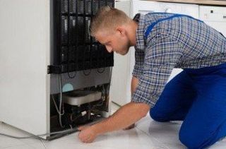 Appliance Repair — Man Repairing The Machine in Phoenix, AZ