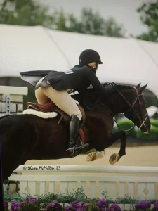 A woman is riding a horse in a photo taken in 2013
