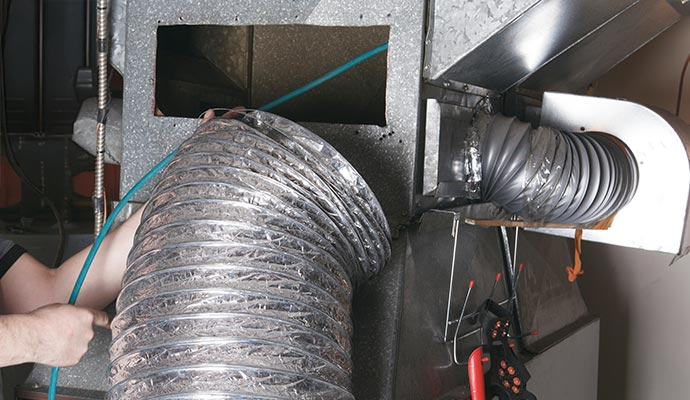 Industrial ceiling with ventilation ducts and track lighting.