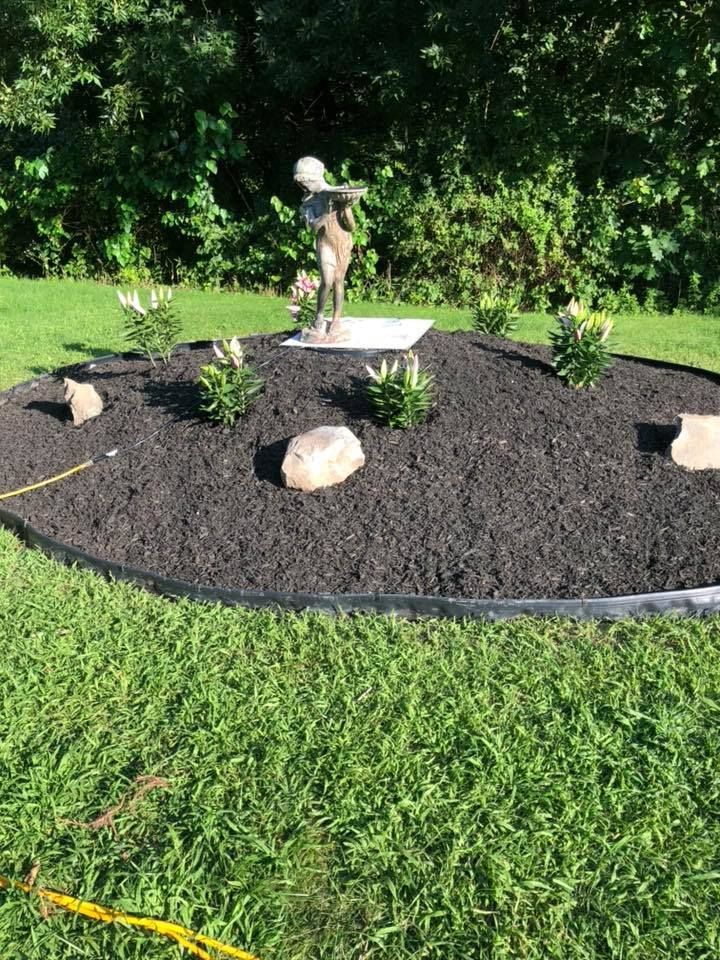 There is a statue in the middle of the garden.