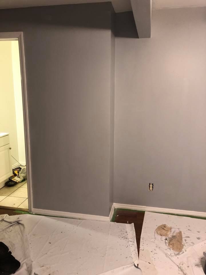 A room is being painted in a basement.