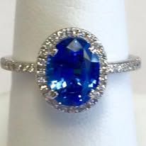 Blue sapphire ring with a diamond halo, close-up.