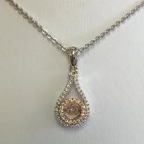 Diamond pendant necklace with a teardrop design.
