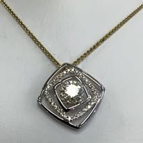 Gold necklace with a diamond pendant in a square design.