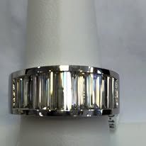 Platinum band ring with baguette-cut diamonds set in a row.