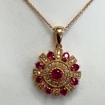Gold pendant necklace with a ruby and diamond circular design.
