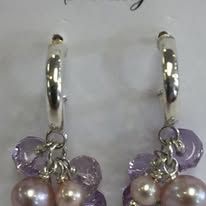 Silver hoop earrings with clusters of pink and purple beads.