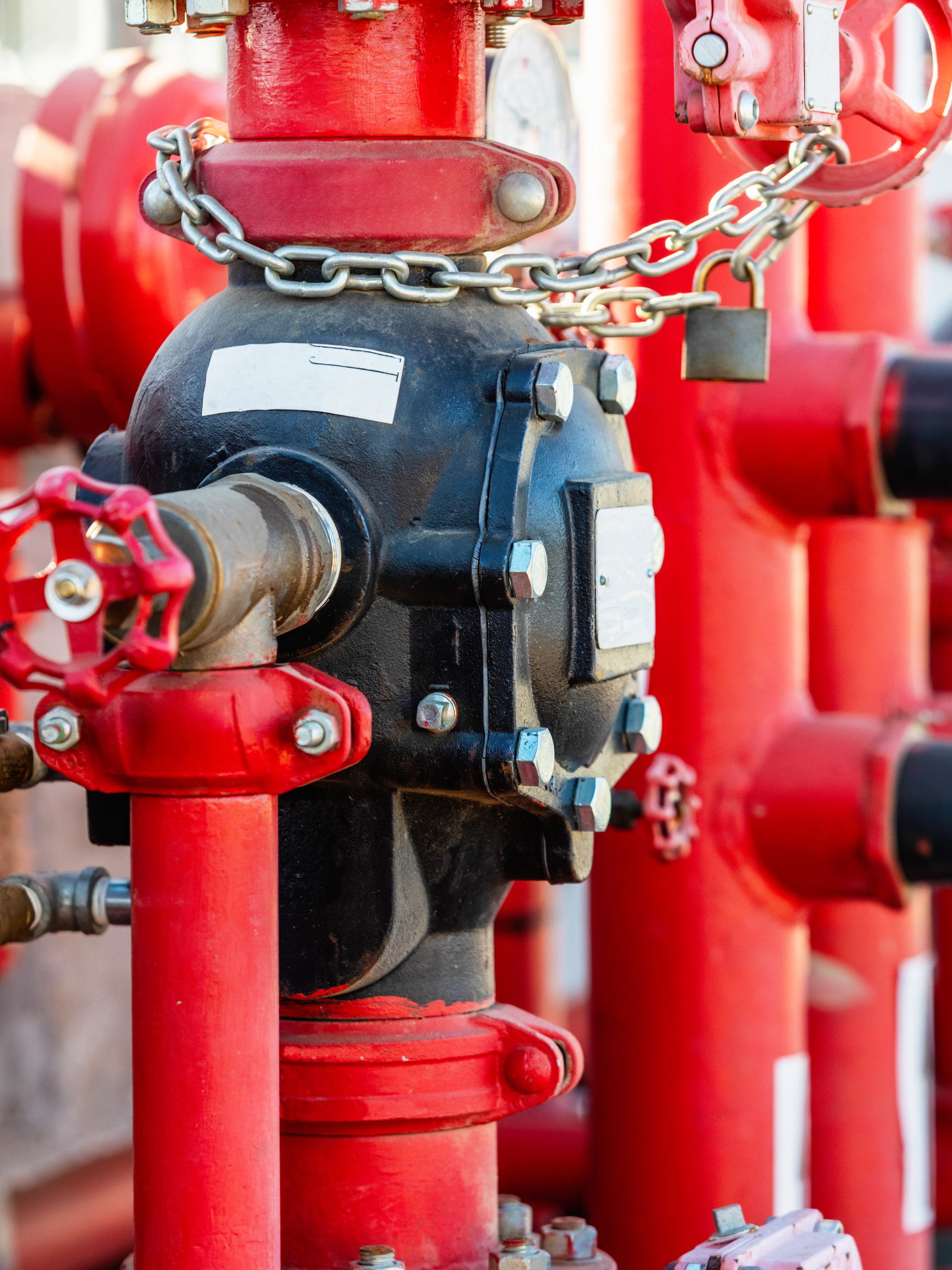 a red and black pipe with a chain around it
