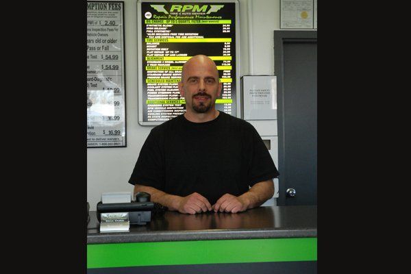 Man RPM Tire & Auto Center Desk — Fairless Hills, PA — RPM Tire & Auto Center