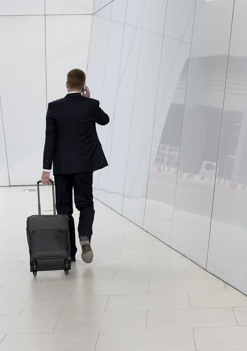 businessman walking a corridor in an airport