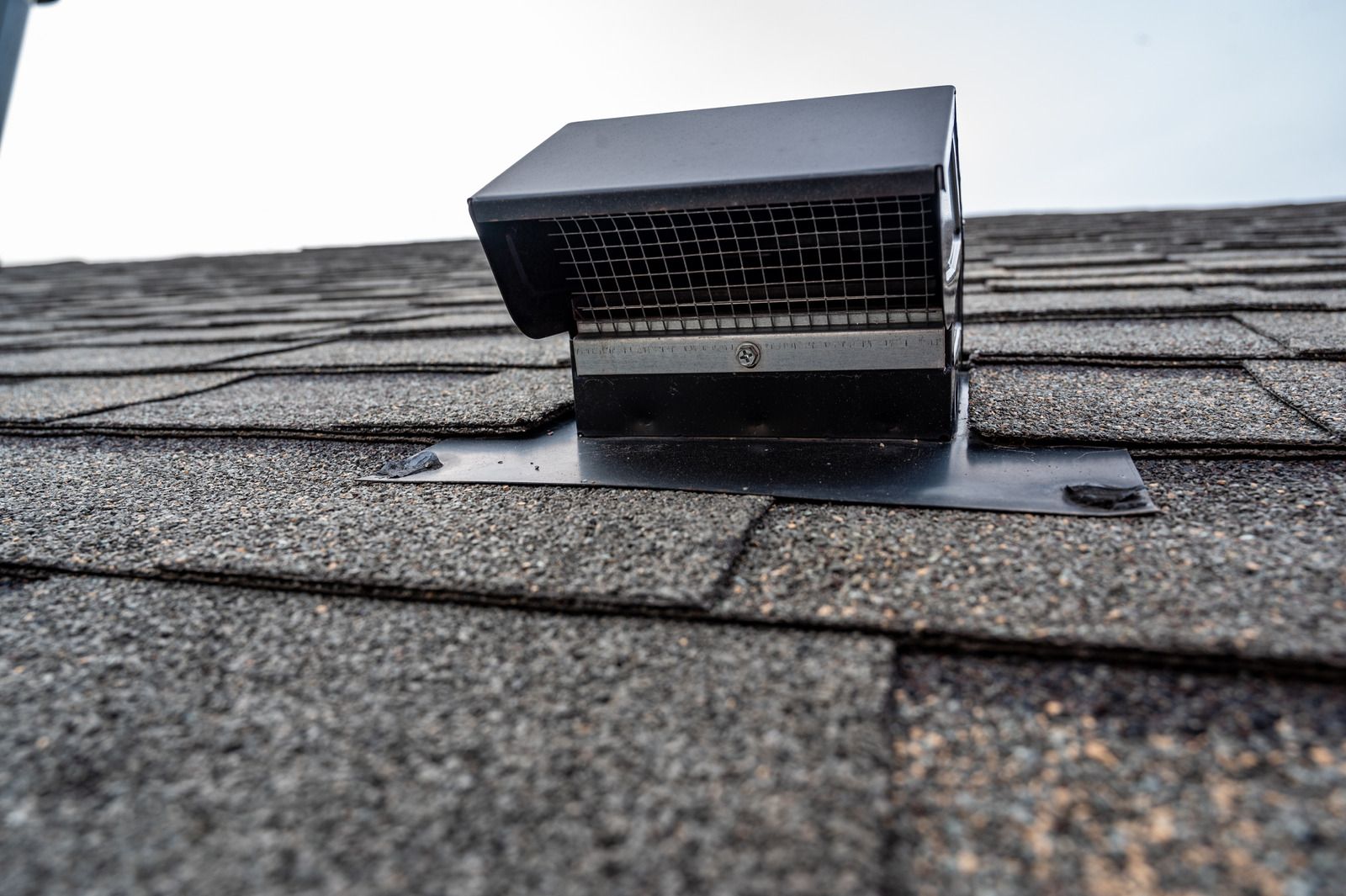 A close up of a roof vent on a roof.
