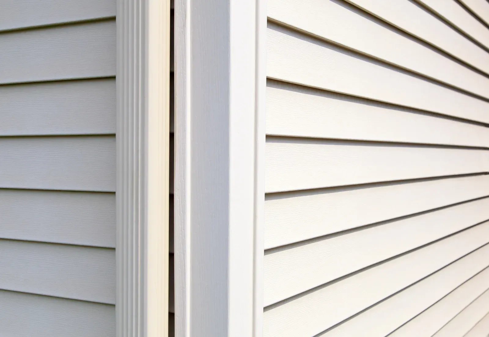 A close up of a white siding on a house