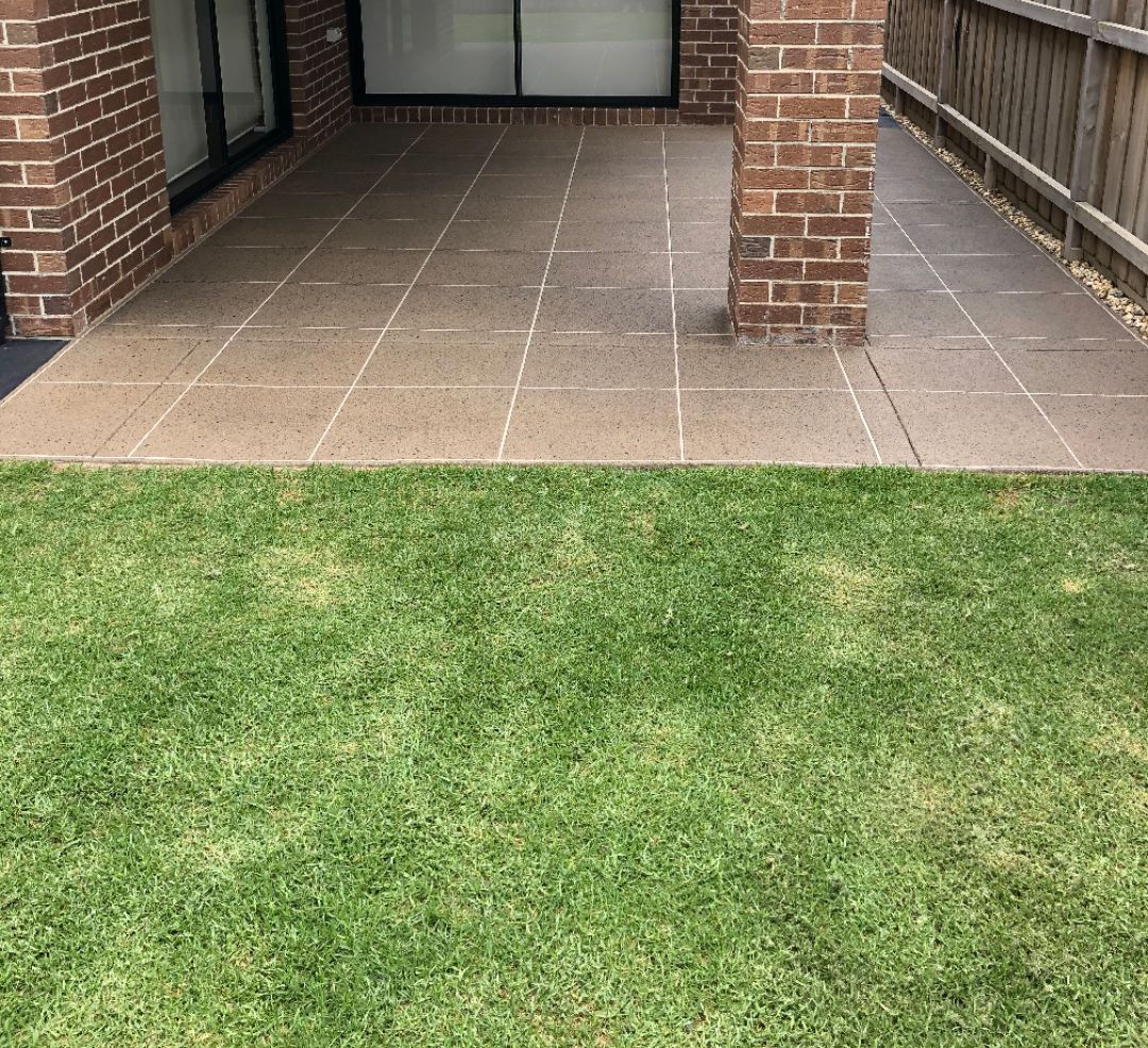 A close up of a brick walkway with a herringbone pattern