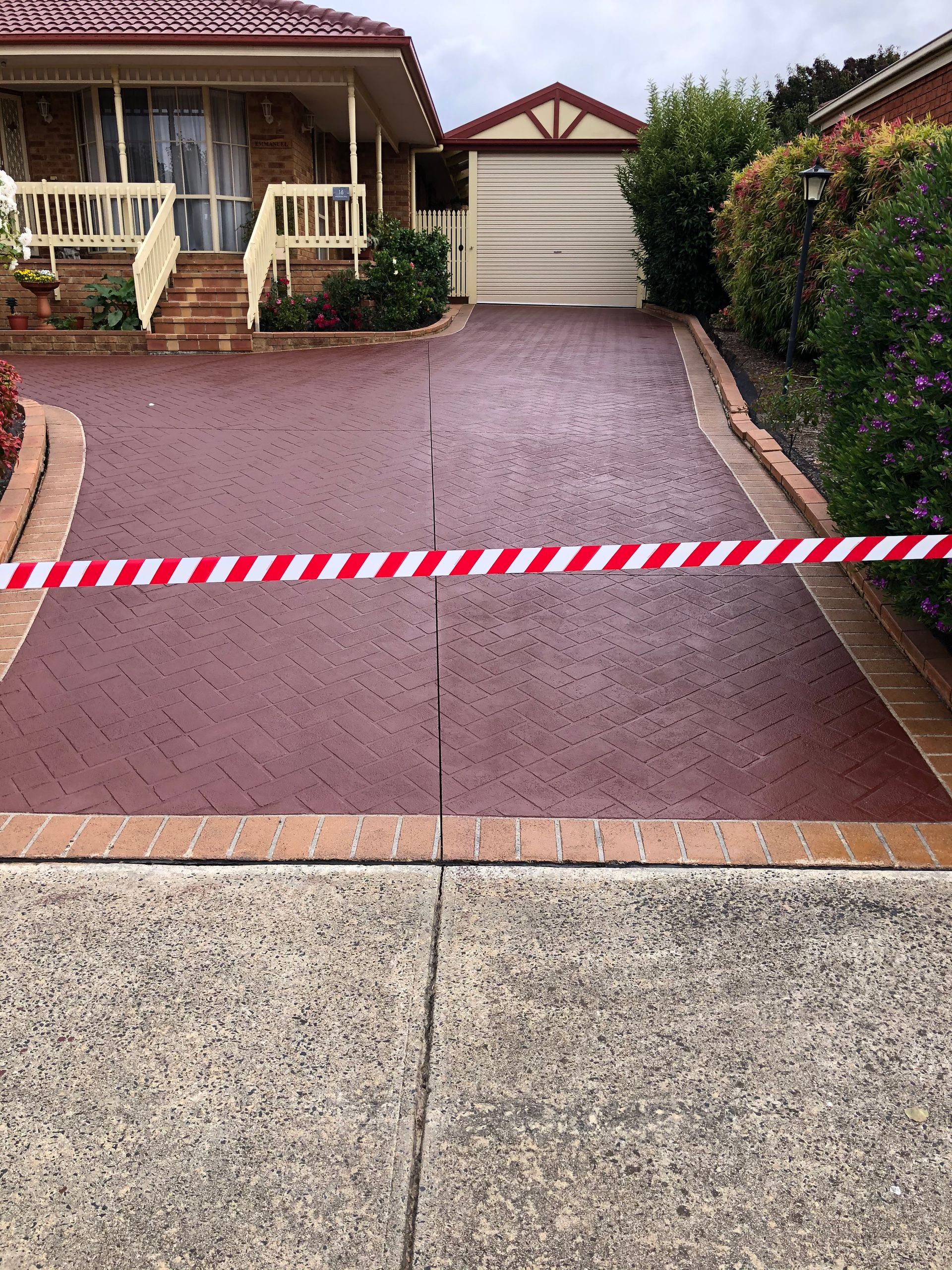 A concrete driveway is being built in front of a house.