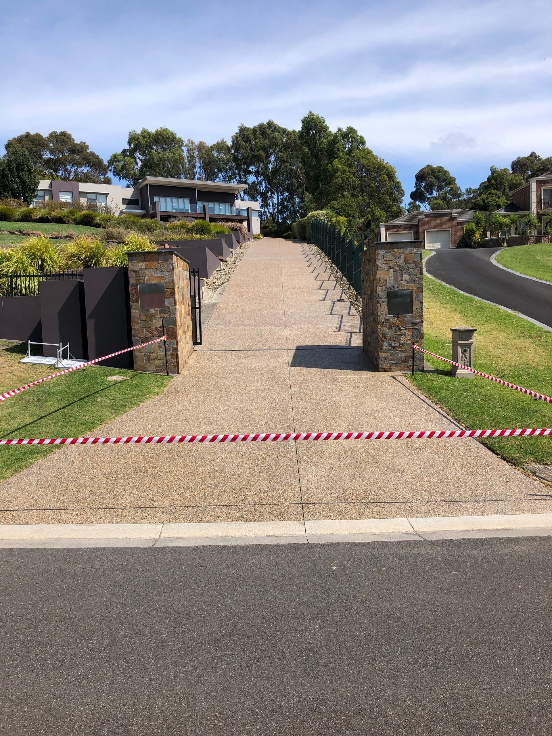 A very Grand home with a long exposed aggregate driveway clean and clear sealed by Melbourne Concrete Sealing in Narre Warren.