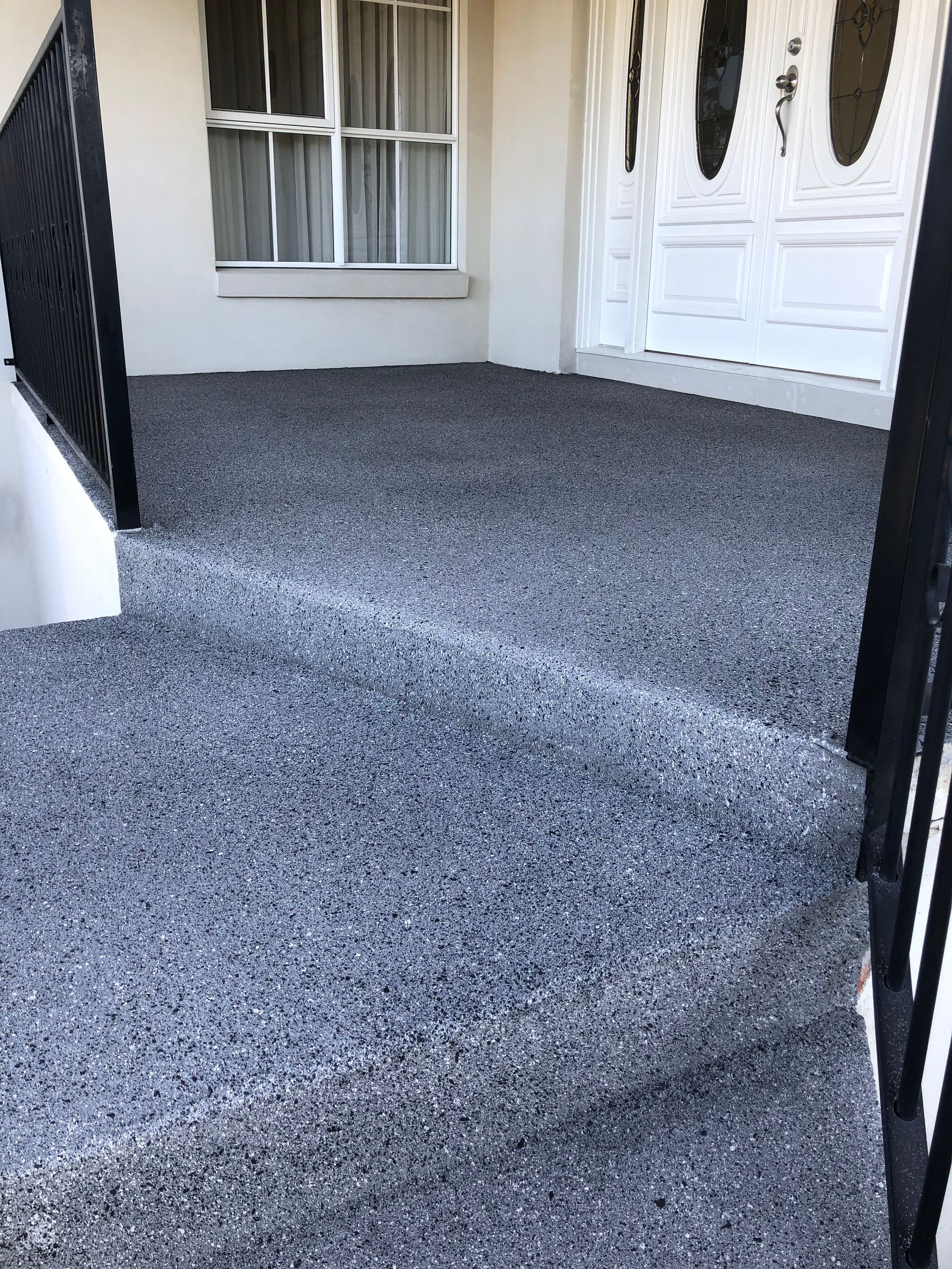 A white  house showing concrete resurfacing and sealing 