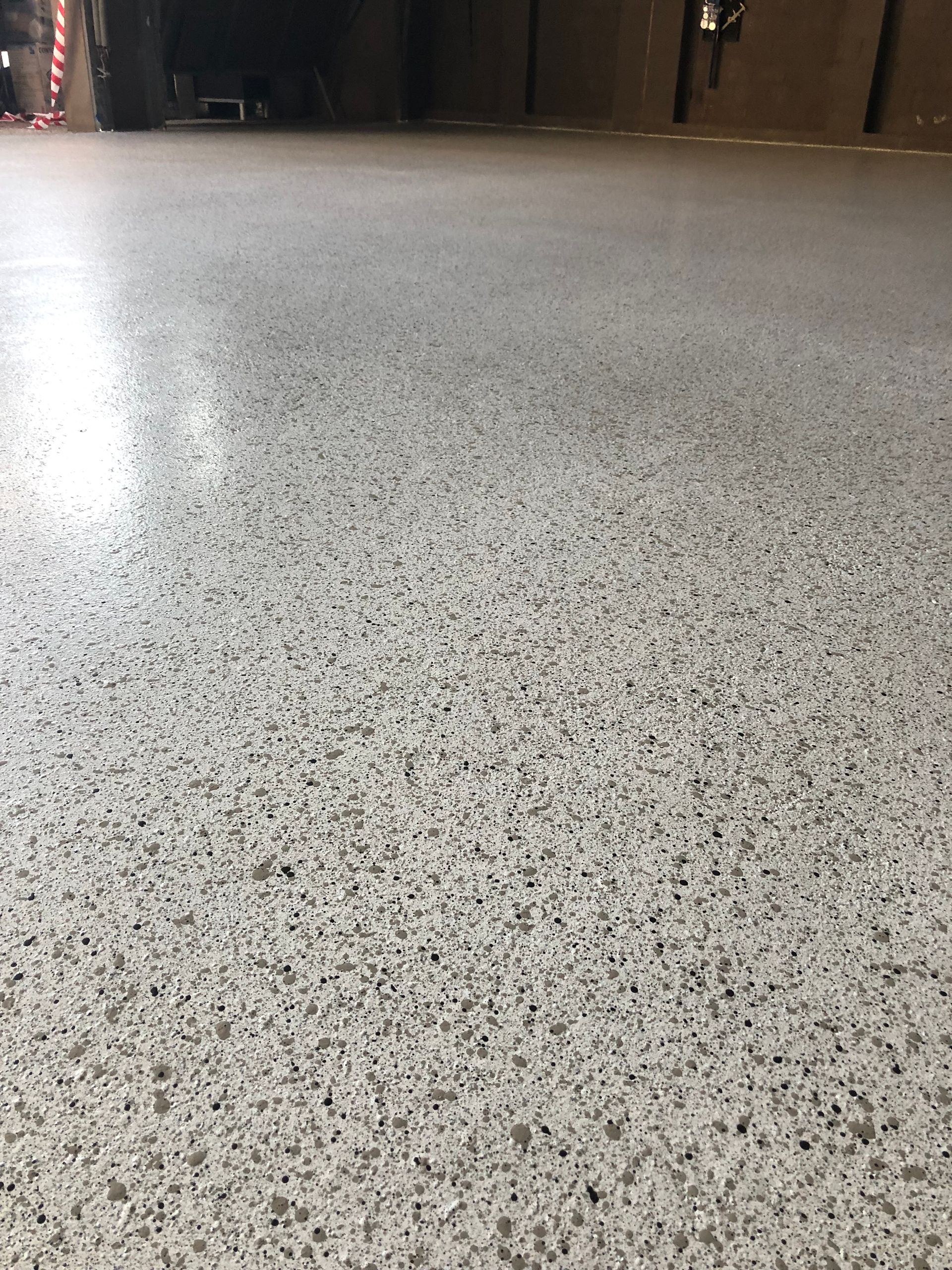Epoxy Garage flooring showcasing stippled stone look by Melbourne Concrete Sealing in Aspendale.