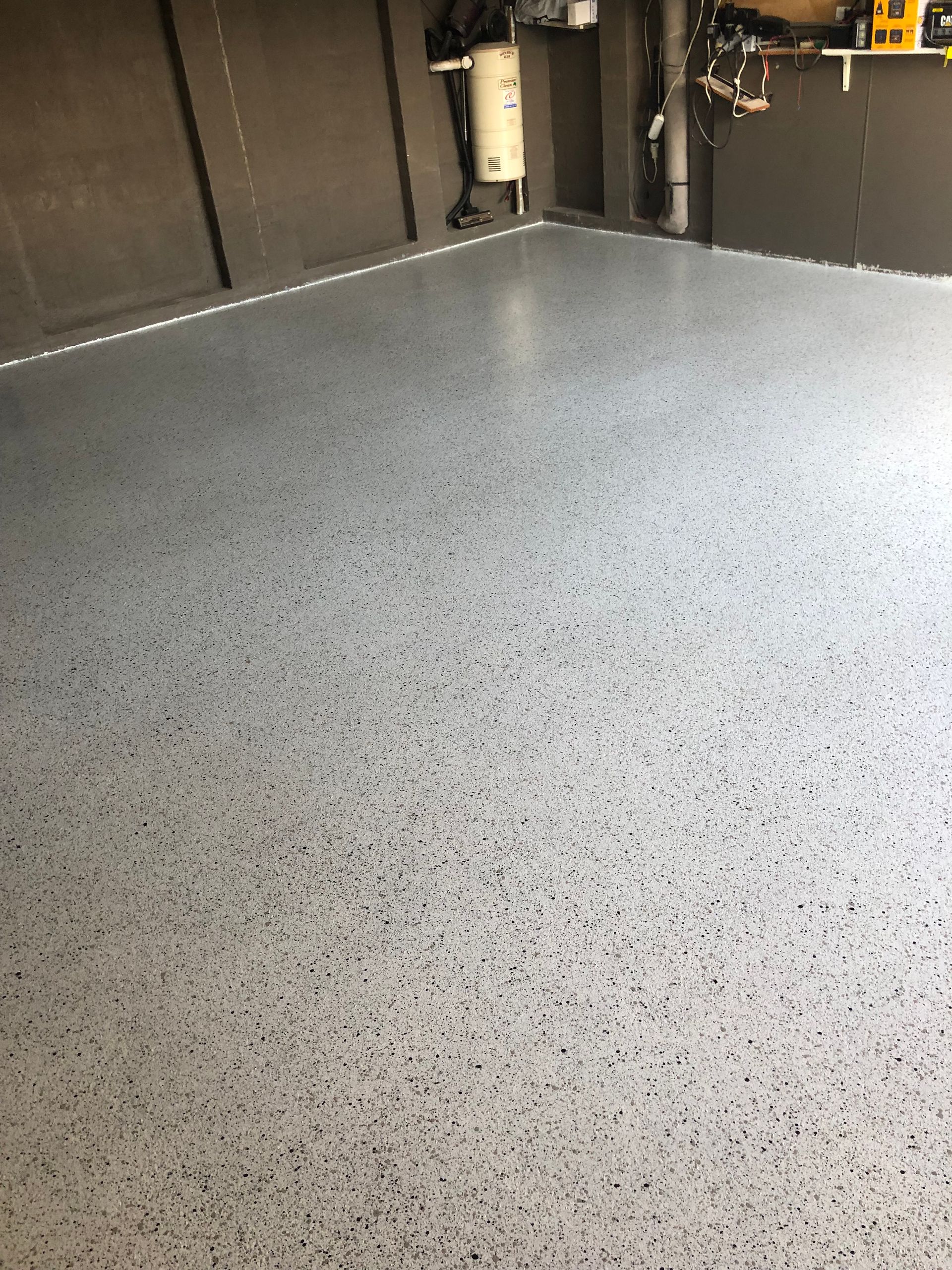 A roller is sitting on the floor in a kitchen.