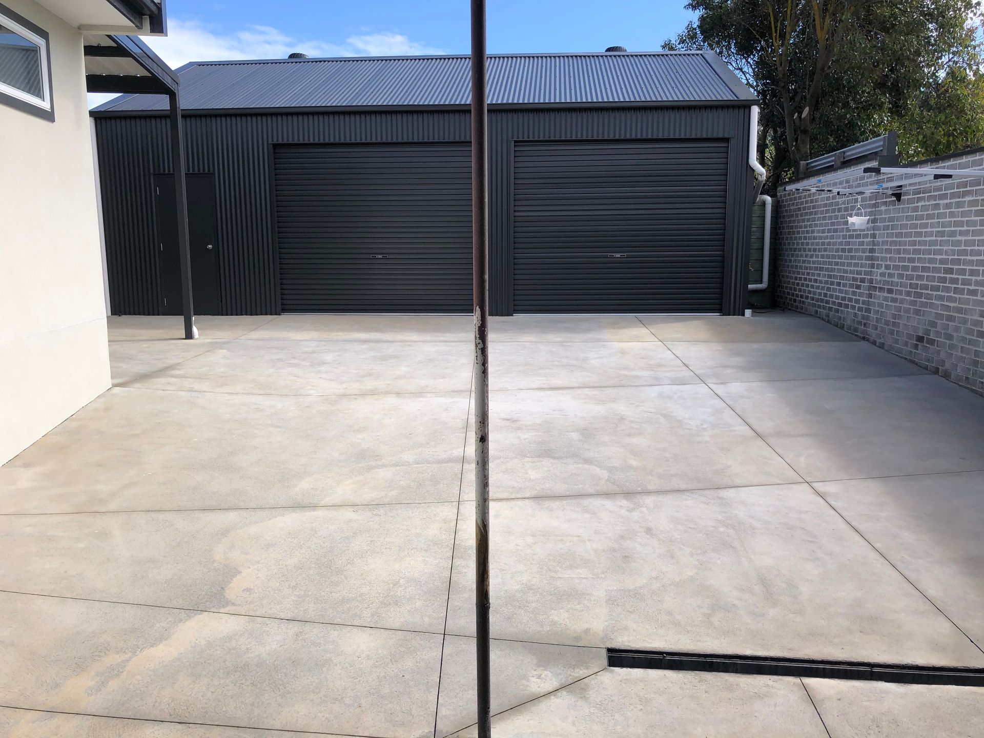 Concrete leading to shed clean after high pressure cleaning.