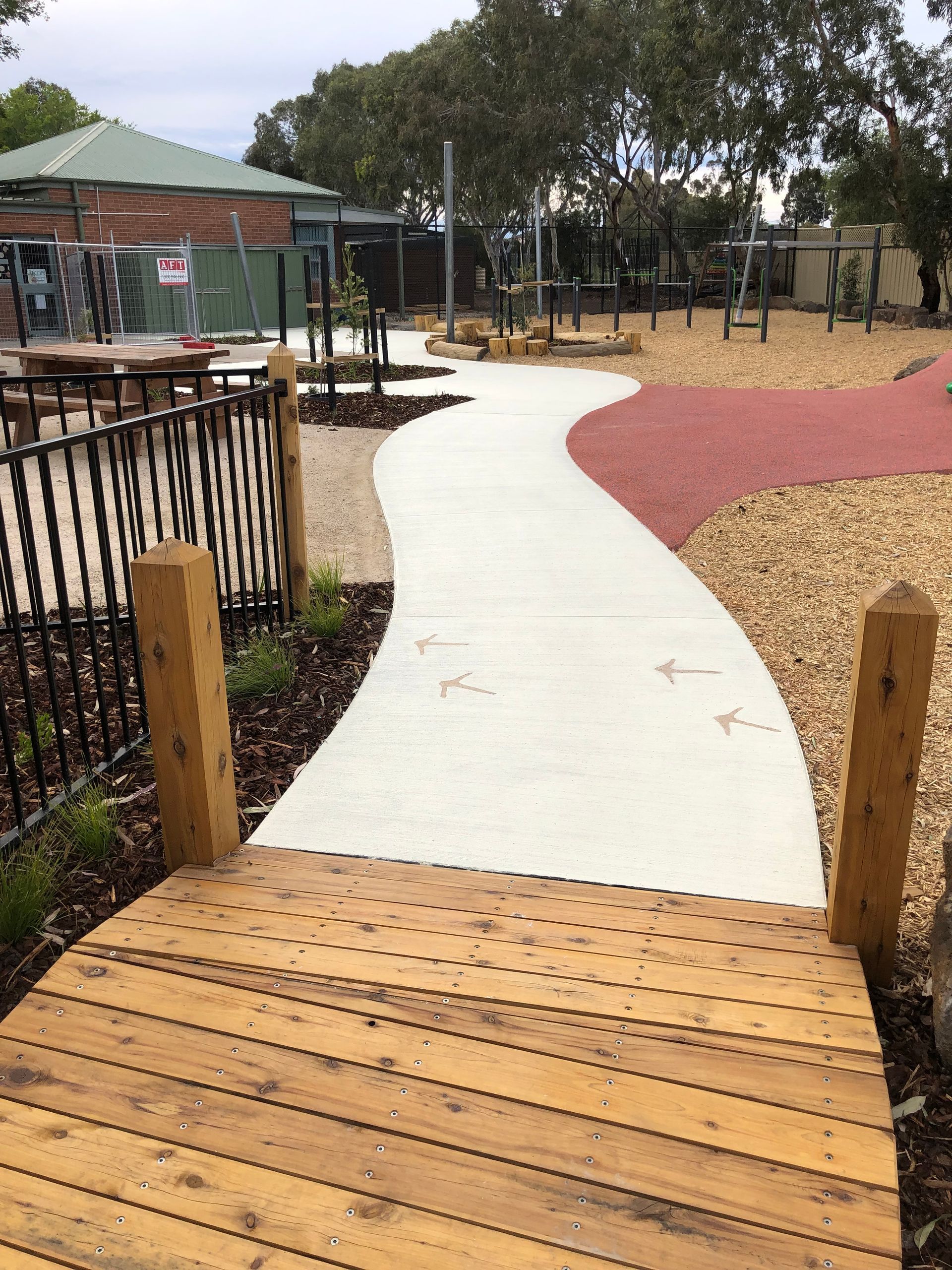 A tiled walkway with a brick wall in the background.