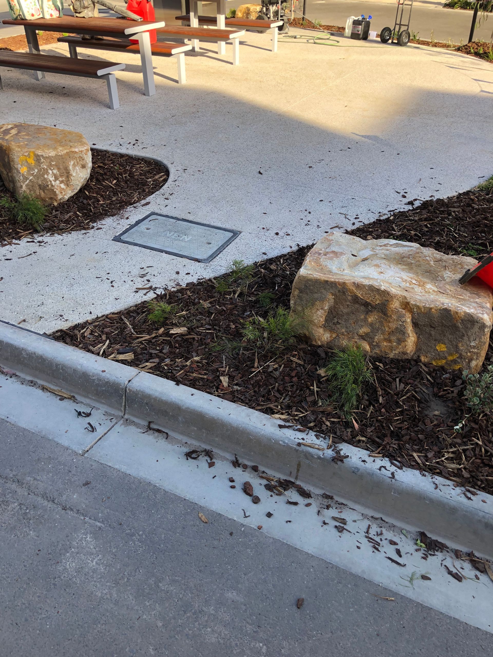 Unsealed and porous exposed aggregate concrete at a Port Melbourne commercial site before professional restoration by Melbourne Concrete Sealing and Resurfacing.