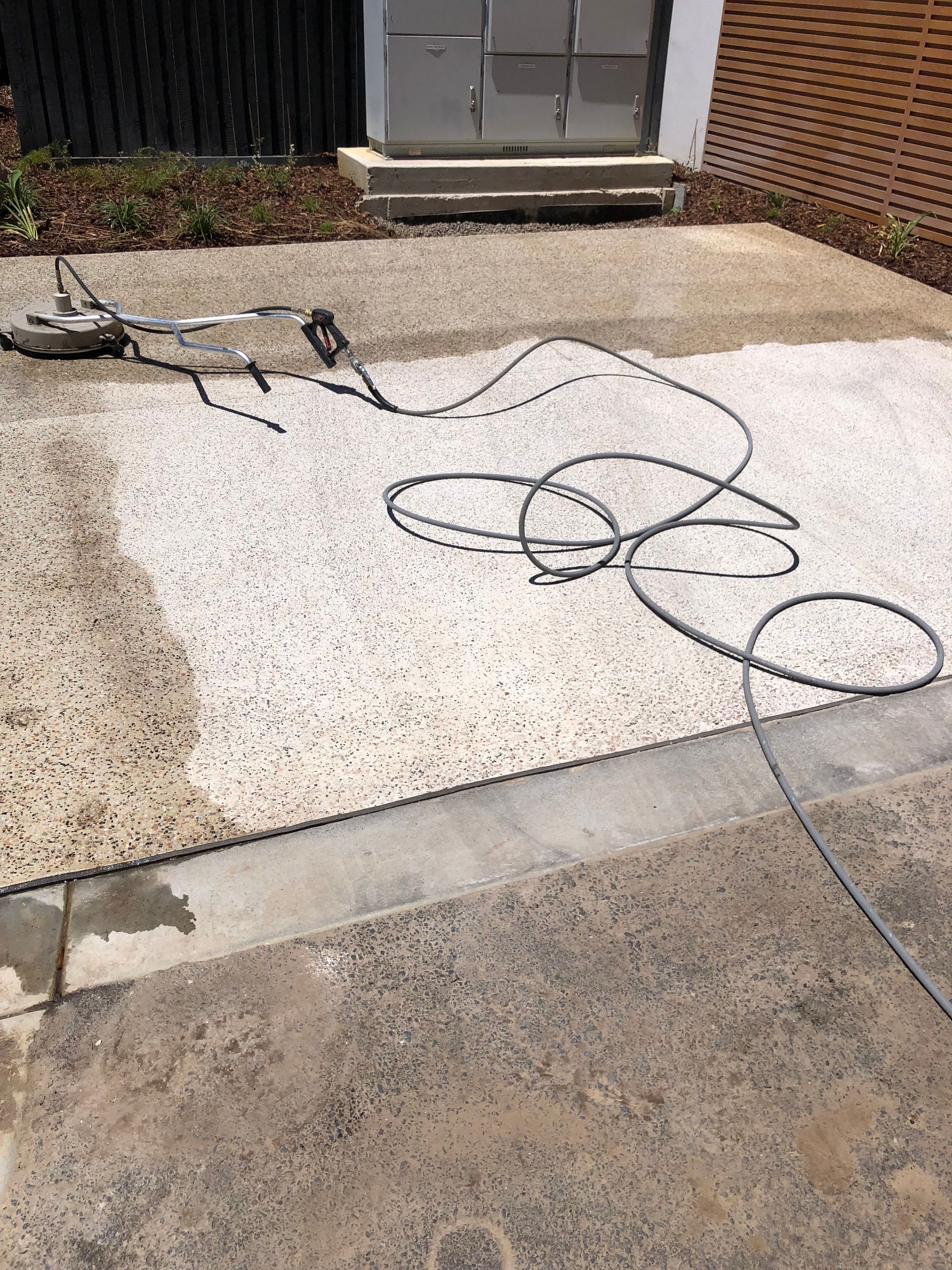 Professional high-pressure concrete cleaning and preparation for exposed aggregate sealing in Port Melbourne by Melbourne Concrete Sealing.